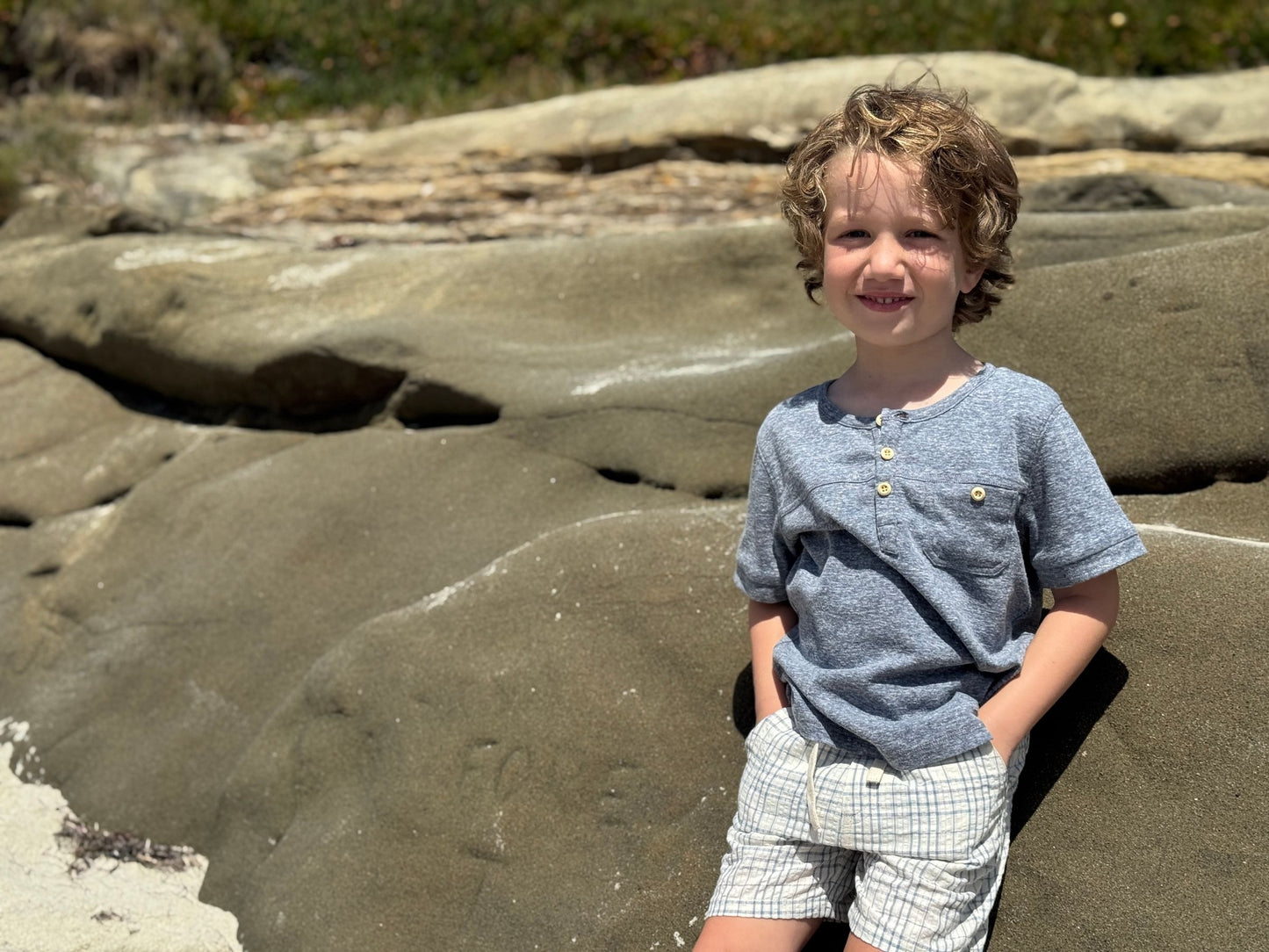 Child standing on a rocky beach